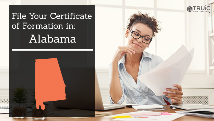 Woman smiling while looking at her certificate of formation for Alabama.