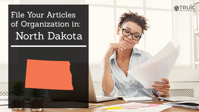 Woman smiling while looking at her articles of organization for North Dakota.