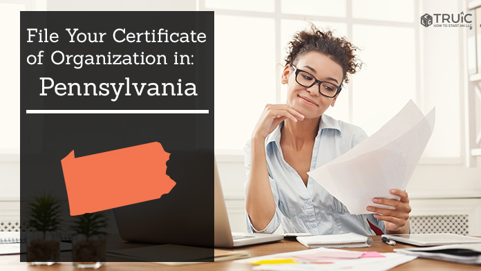 Woman smiling while looking at her certificate of organization for Pennsylvania.