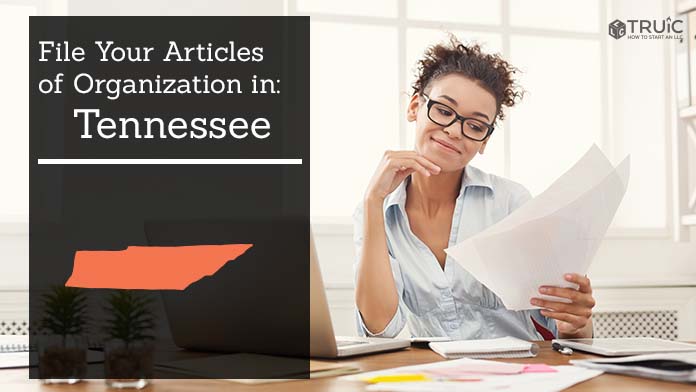 Woman smiling while looking at her articles of organization for Tennessee.