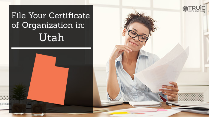 Woman smiling while looking at her certificate of organization for Utah.