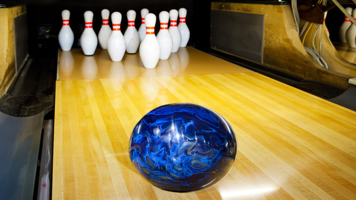 bowling alley with pins and a bowling ball
