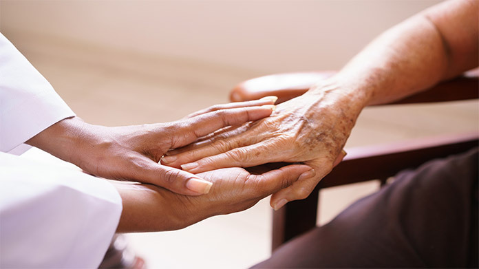 Hospice nurse giving comfort to another person