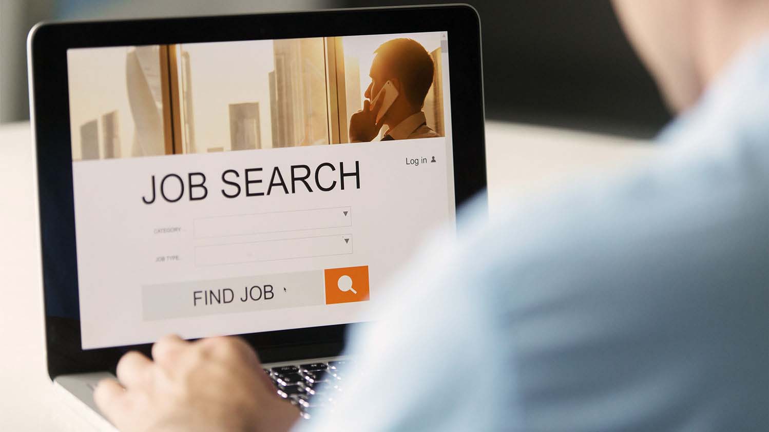 A person on a laptop performs a job search