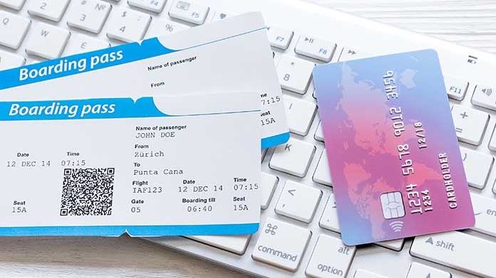 two boarding passes next to a credit card for airline miles