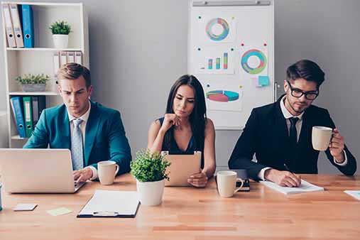 Three people working at a table