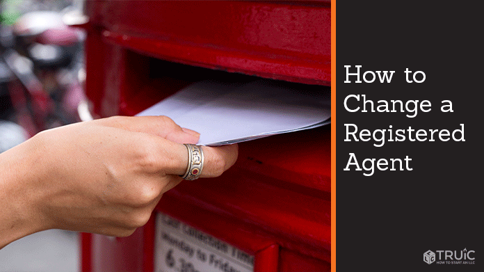 hand putting a letter into red post office mailbox