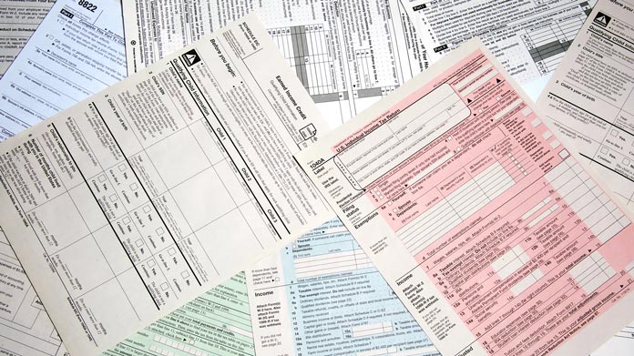 A disorganized pile of tax forms